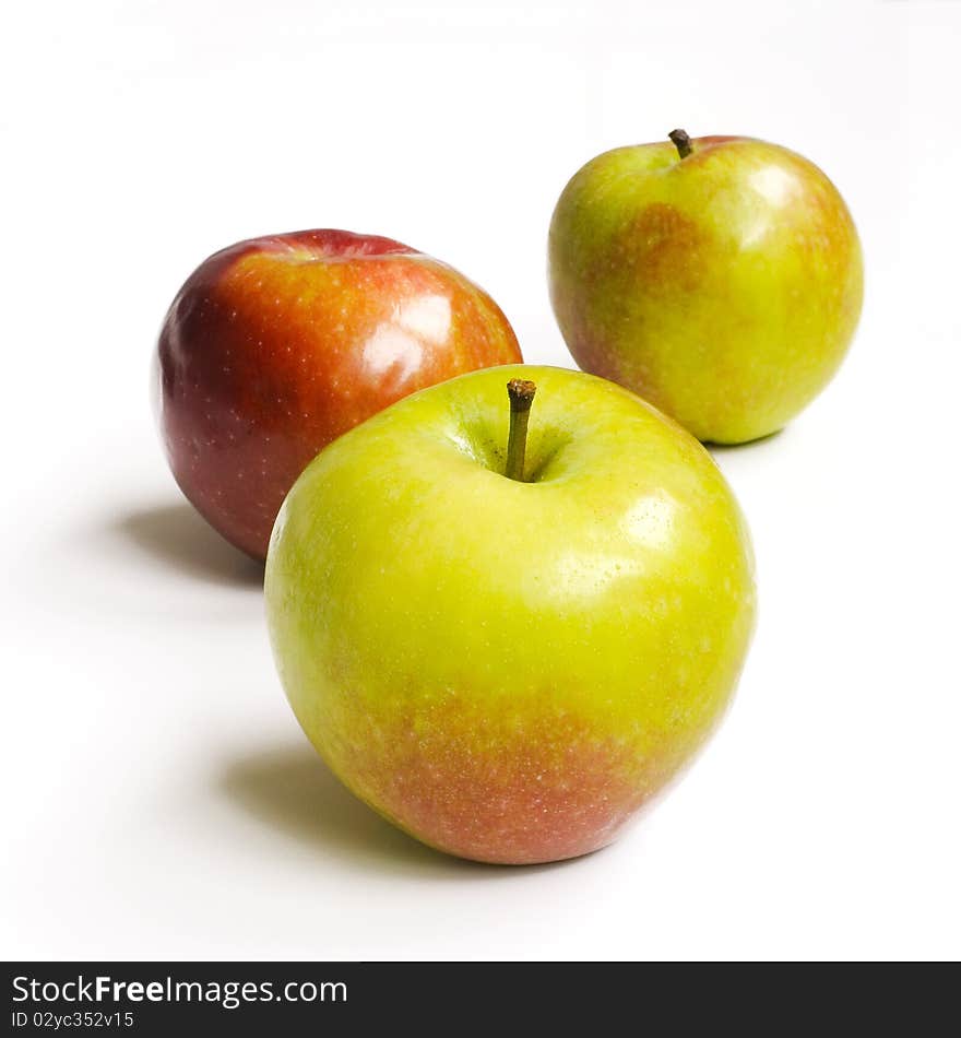 Three fresh red-green apples on white