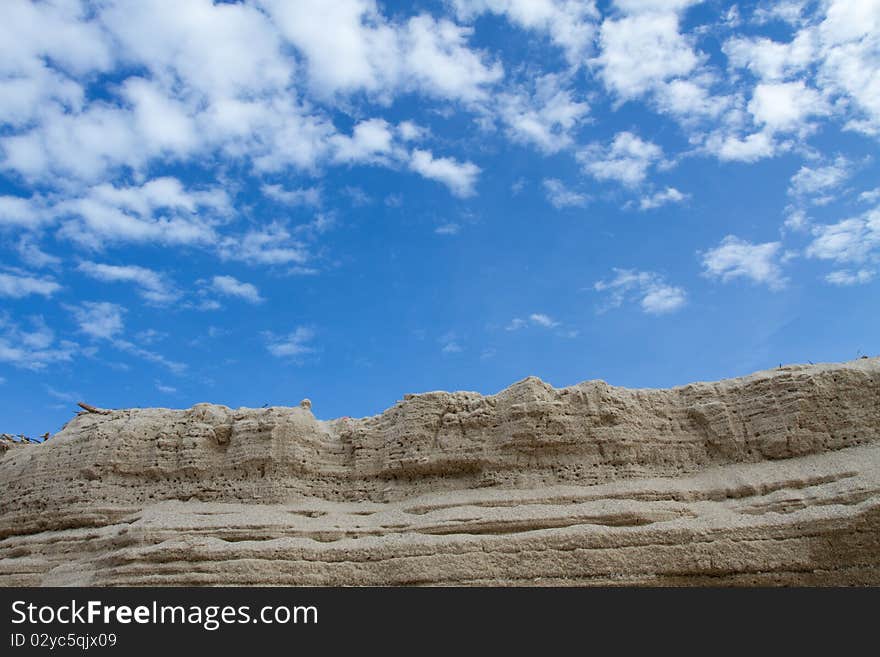 The sand that pile up to is , and have the background is the sky. The sand that pile up to is , and have the background is the sky