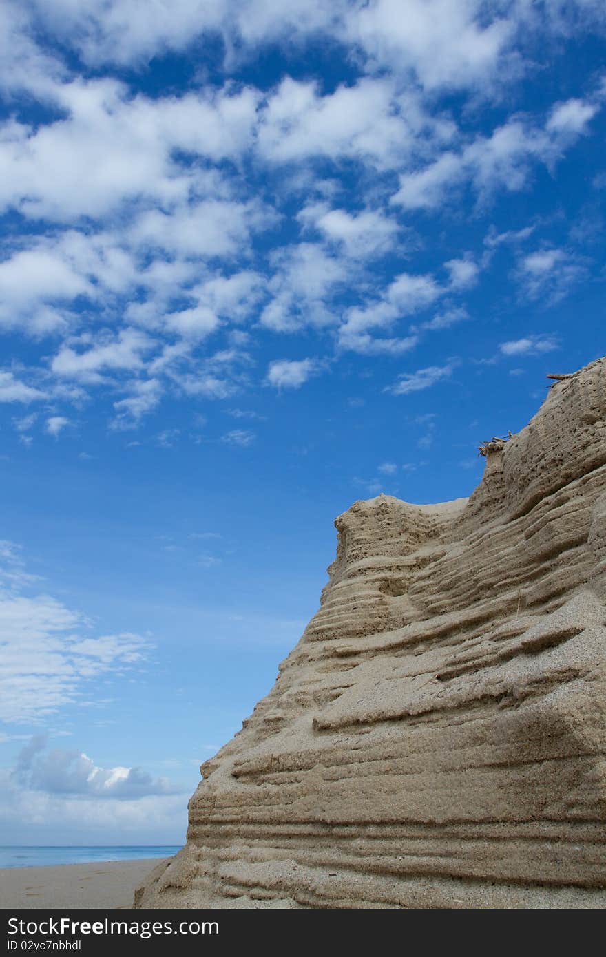 The sand that pile up to is , and have the background is the sky. The sand that pile up to is , and have the background is the sky