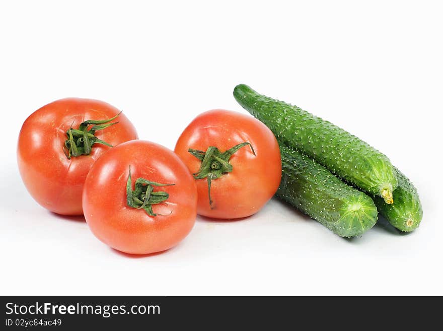 Tomato and cucumber on white background