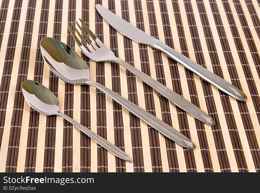 Flatware set: fork, knife spoon - on mad background