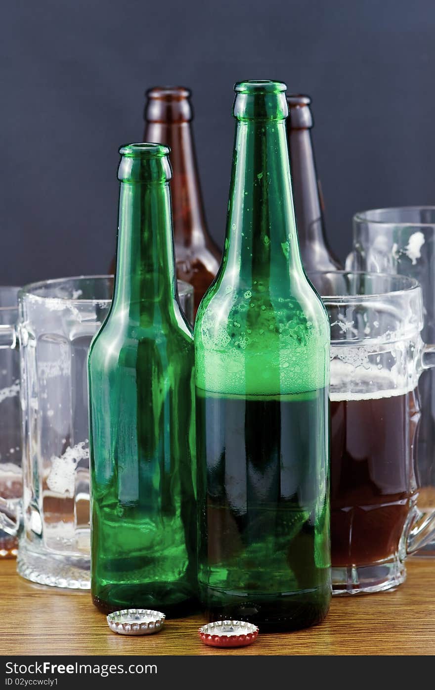 Beer bottles and mugs on wood counter