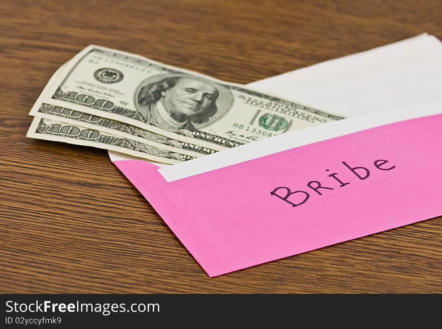 Pink envelope with money on wood table. Pink envelope with money on wood table