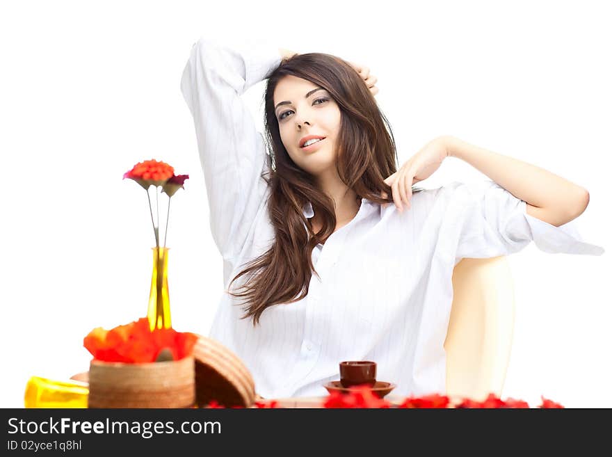 Beautiful woman  in cafe over white background with red  flowers