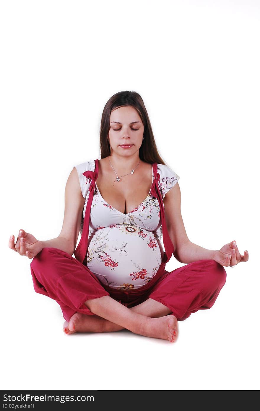 Pregnant woman in the studio on a white background