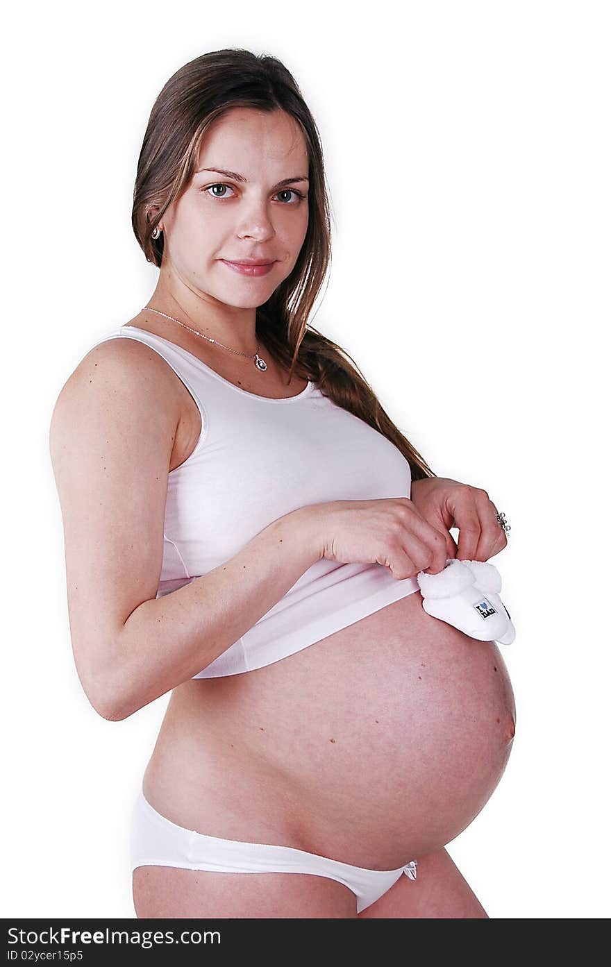 Pregnant woman in the studio on a white background