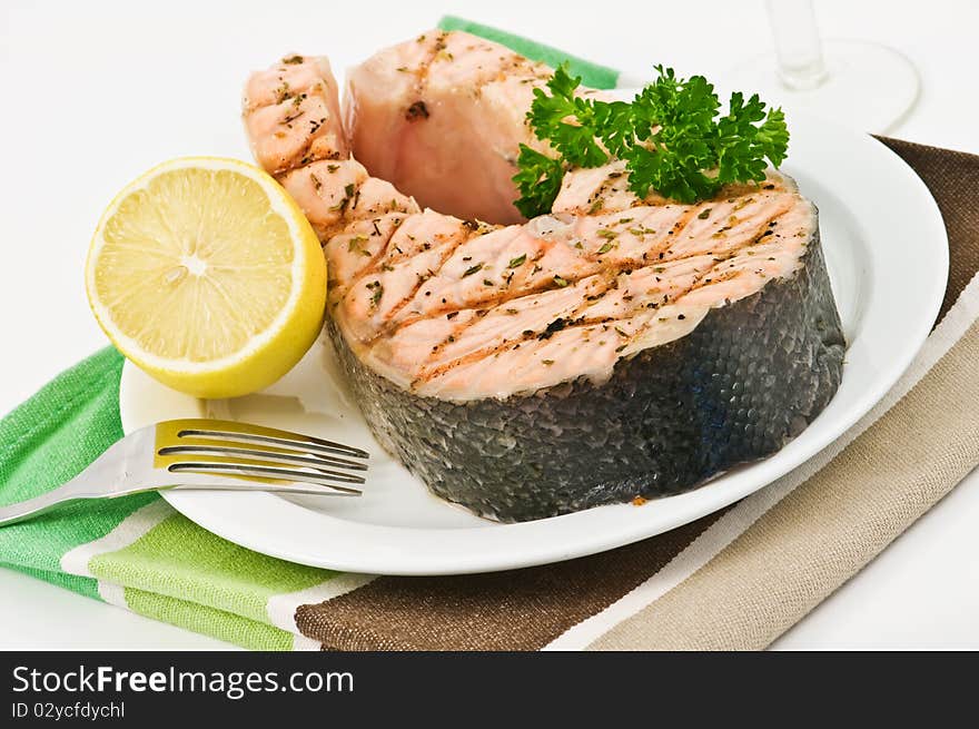 Grilled salmon steak on plate