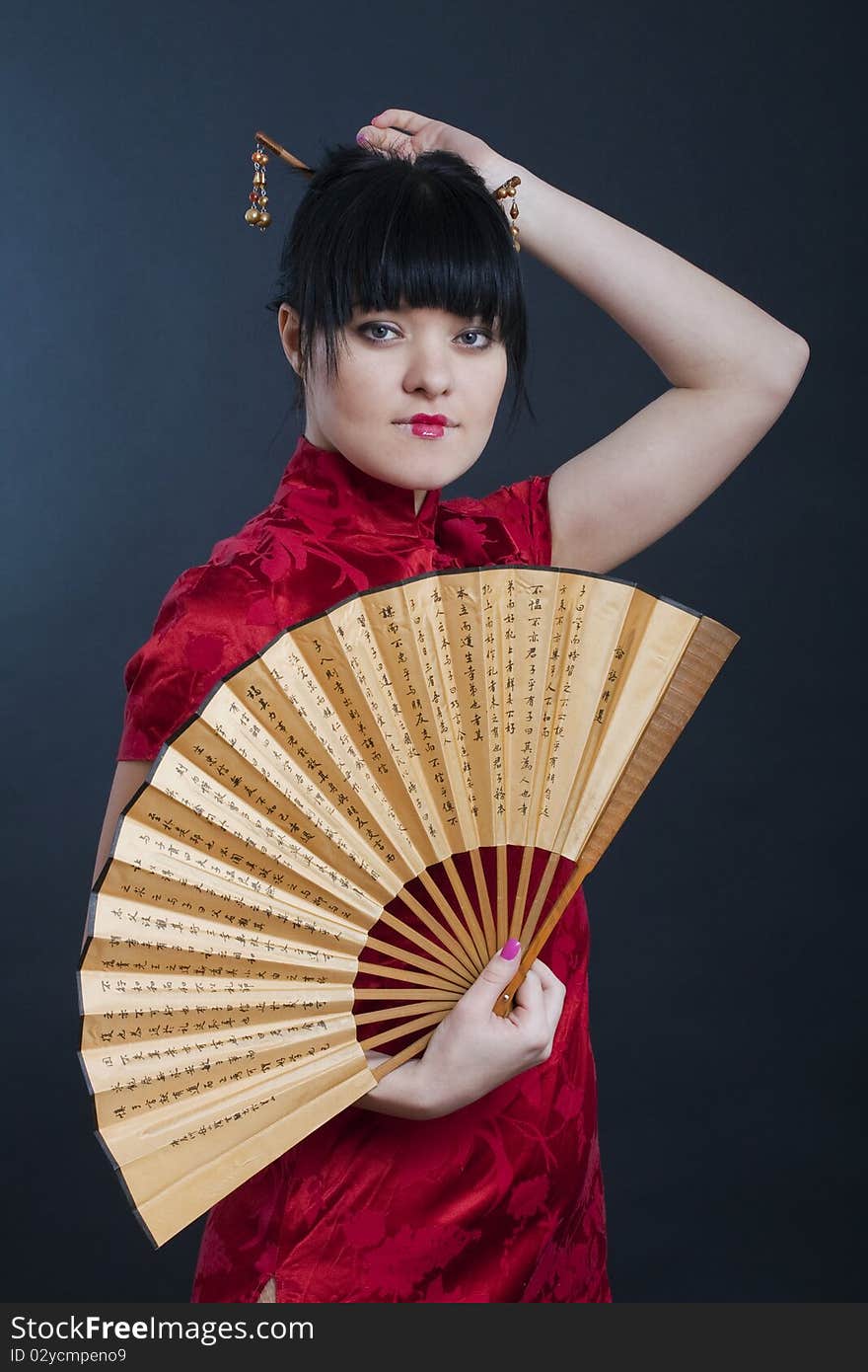 Portrait of girl in geisha costume on black background