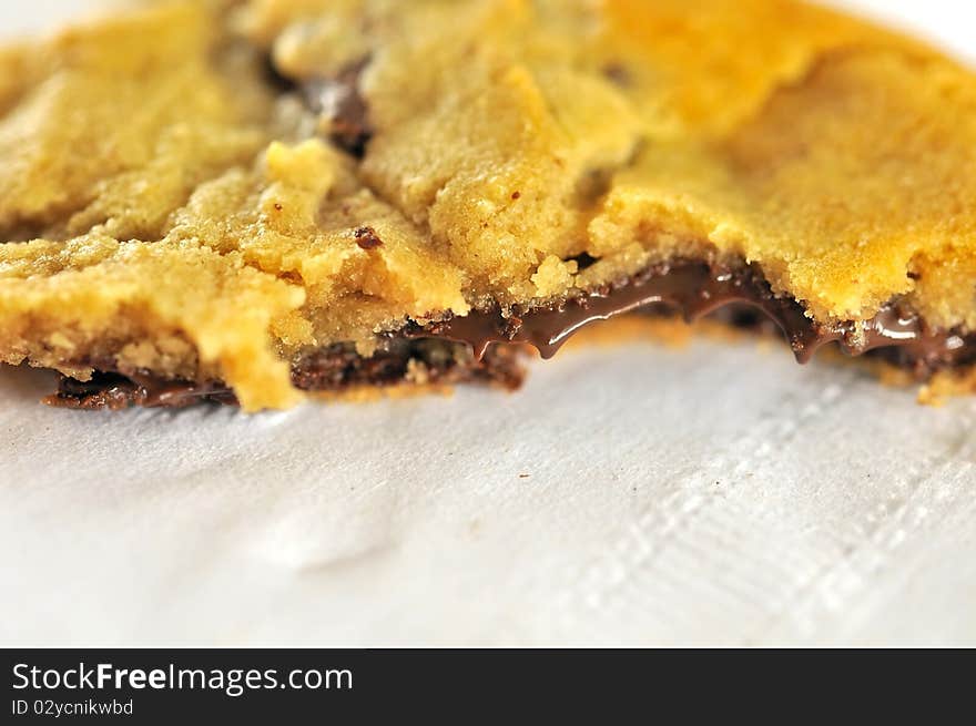 Half eaten cookie with sumptuous chocolate liquid filling oozing out. Half eaten cookie with sumptuous chocolate liquid filling oozing out.