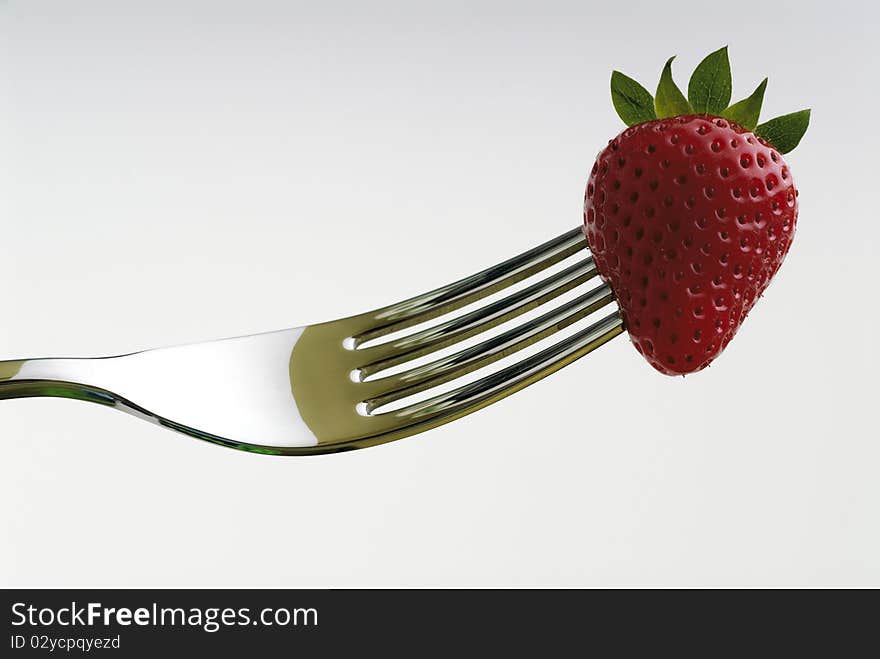 Strawberry skewered by a fork