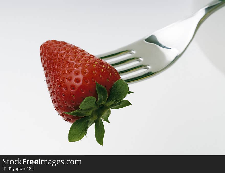 Strawberry skewered by a fork