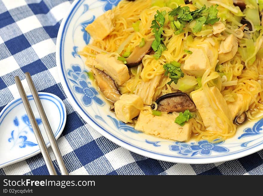 Closeup of delicious Chinese noodles cooked with healthy vegetables.