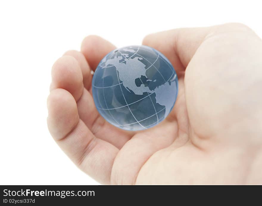 Blue crystal globe in hand with clipping path