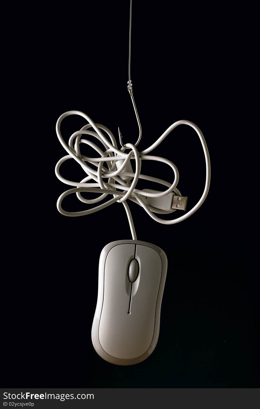 Mouse hanging by its cable to a hook. Mouse hanging by its cable to a hook