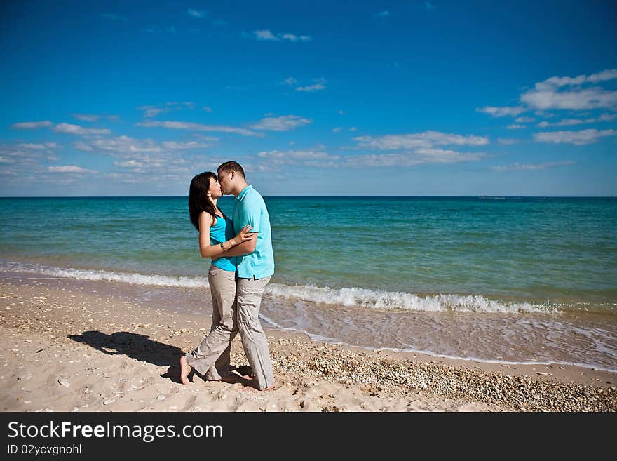 A couple on beach kissing