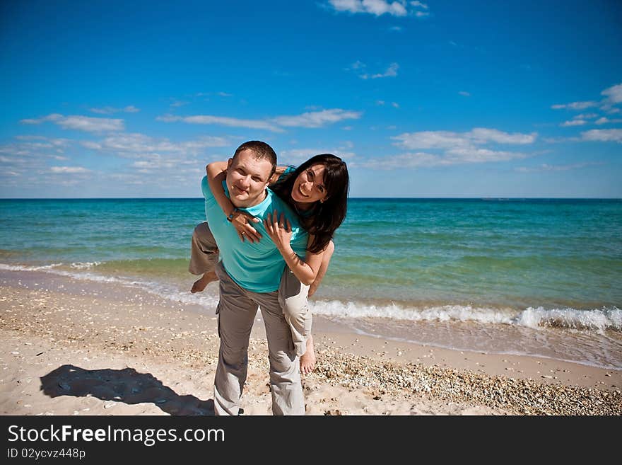 A couple on beach have fun