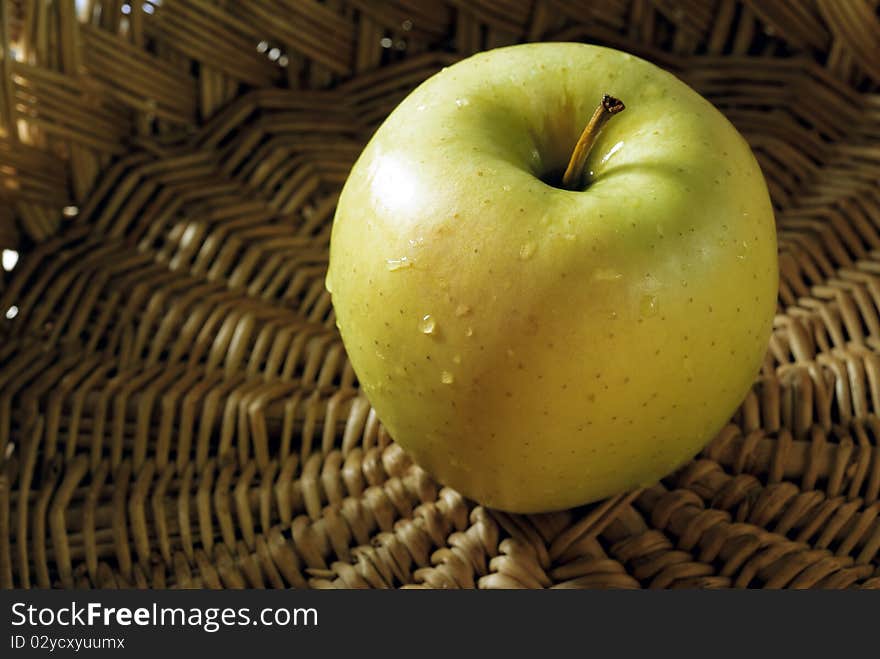 Green apples in a wicker basket