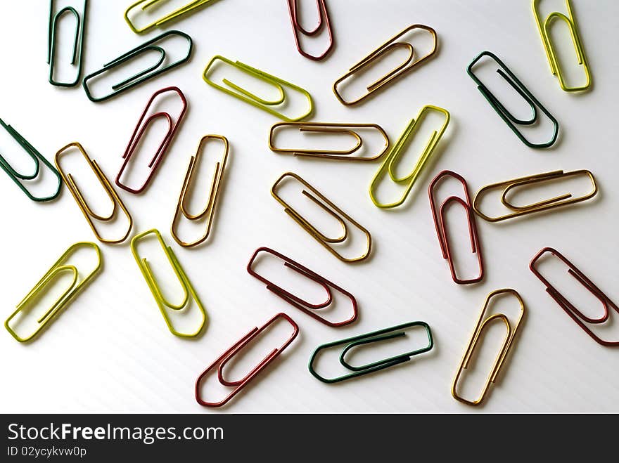 Colorful paper clips on a white surface