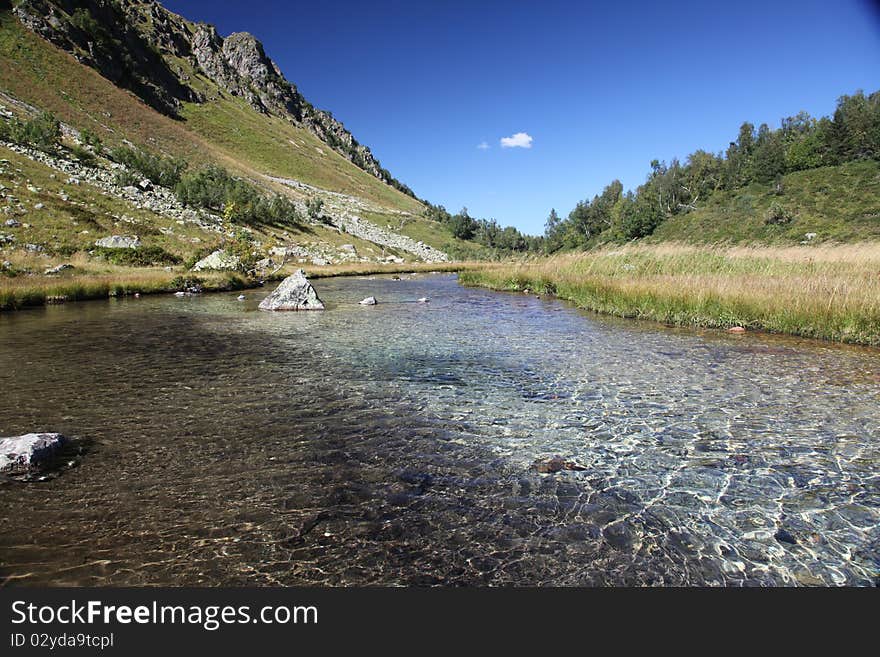 Part of high-mountainous lake located at height 2300меters above sea level. Russia, west Caucasus. Part of high-mountainous lake located at height 2300меters above sea level. Russia, west Caucasus