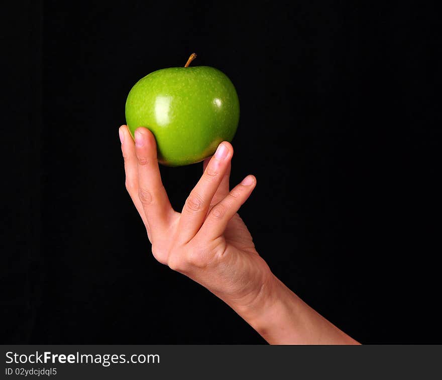 Female hand holding a green apple