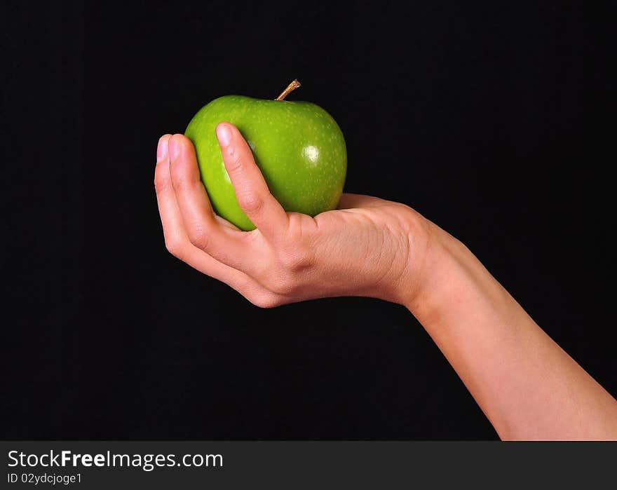 Female Hand Holding A Green Apple