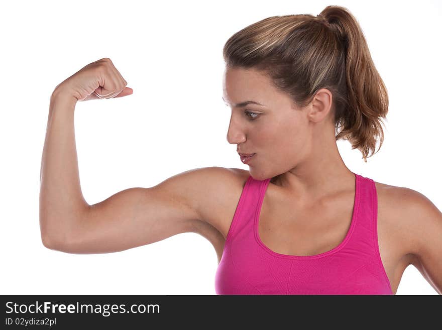 A fit woman is happy with her toned bicep. A fit woman is happy with her toned bicep