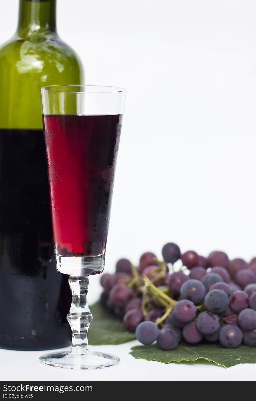 Red wine and grapes isolated in white