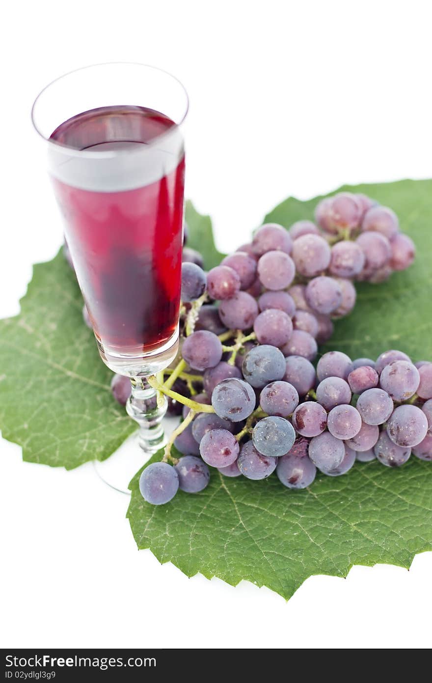 Red wine and grapes isolated in white