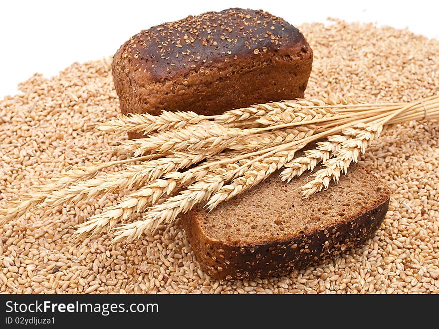 Bread with wheat and ears on white