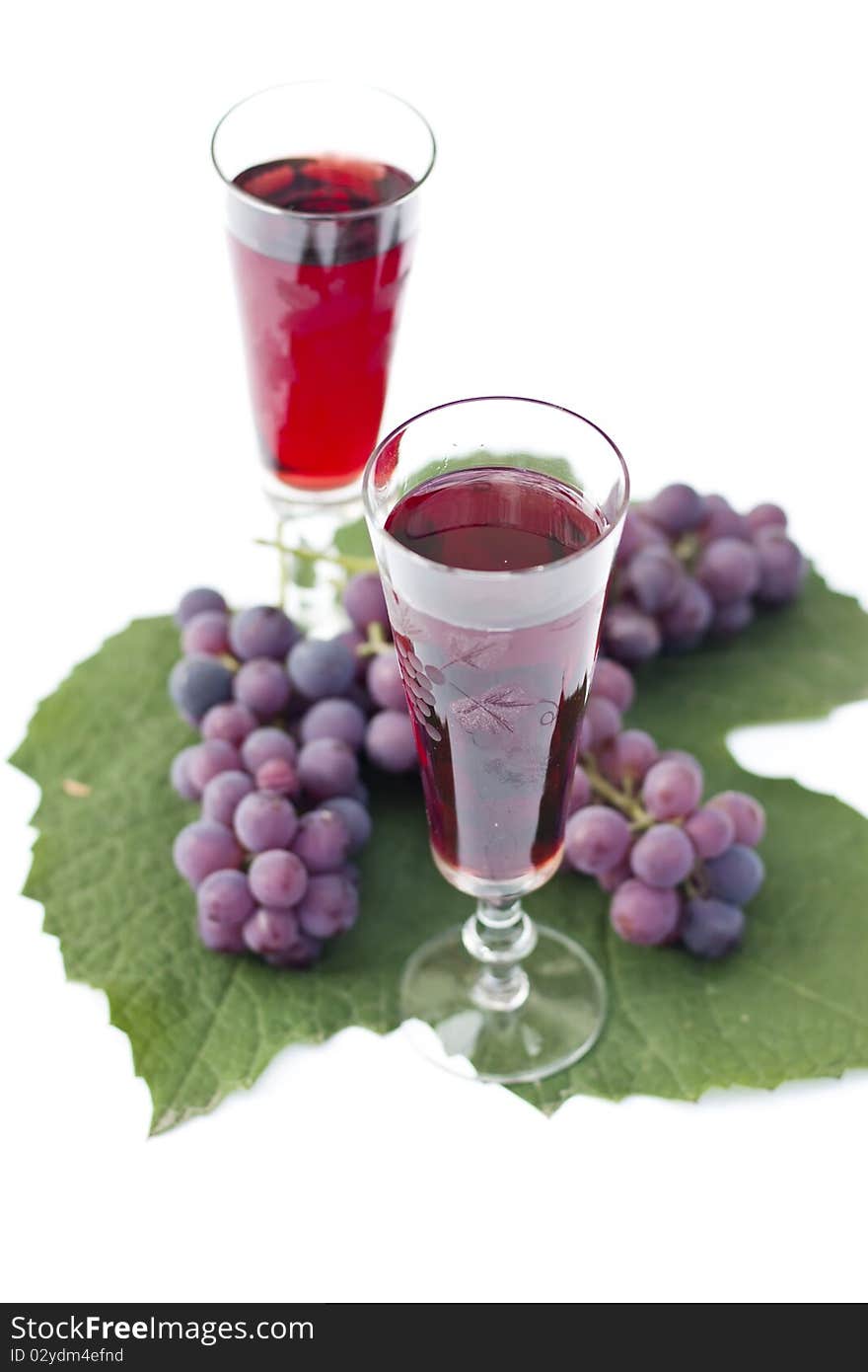 Red wine and grapes isolated in white