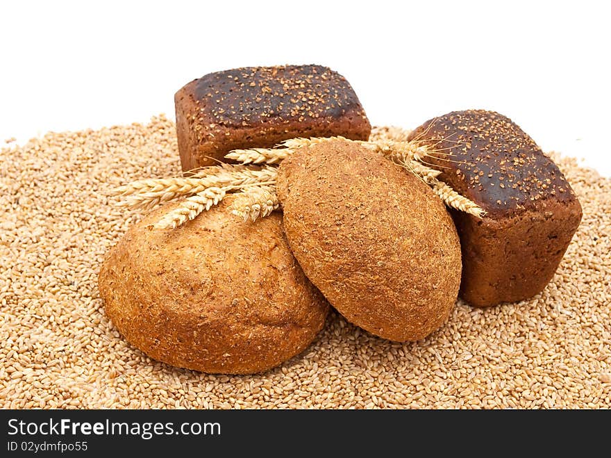 Bread with wheat and ears on white