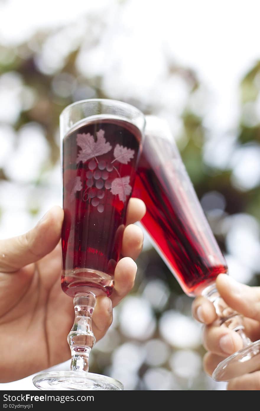 Two wine glasses in toasting gesture