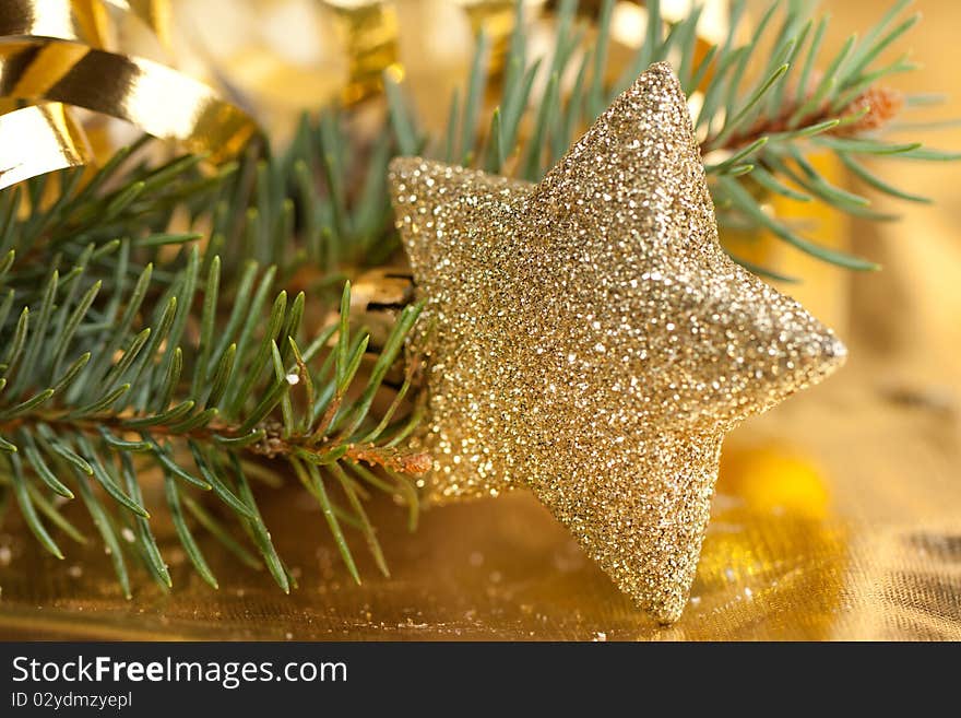 Golden christmas star with christmas tree on the gold background