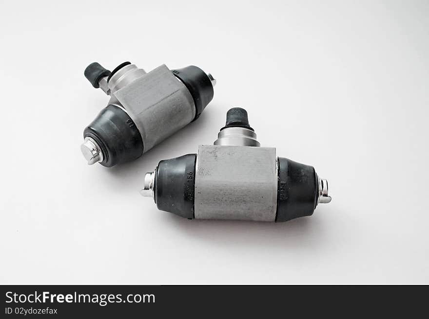 Pair of hydraulic brake cylinders on an isolated white background