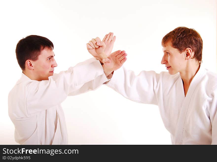 Two karatekas on a dark blue background. Two karatekas on a dark blue background.