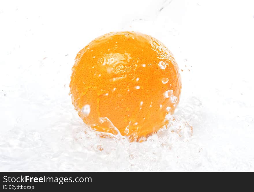 Orange in spray of pure water, isolated on white background