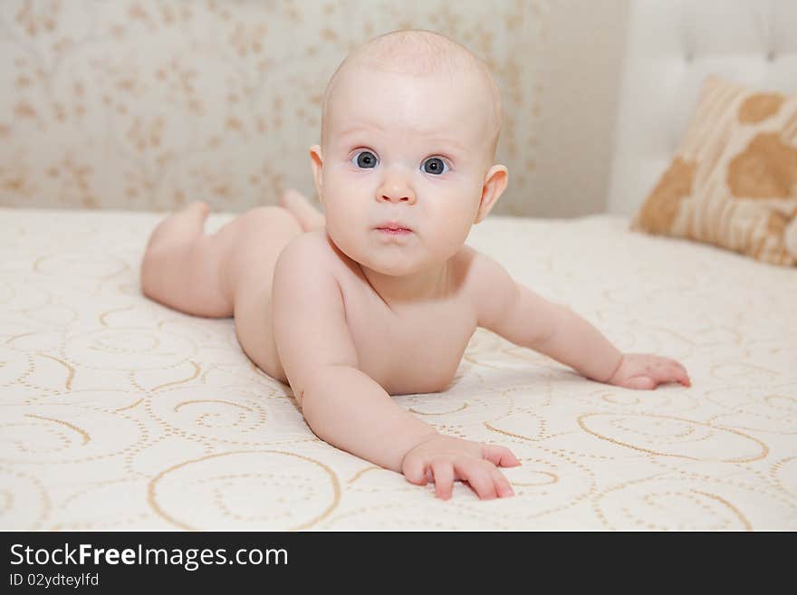 Little sweet baby girl on bed