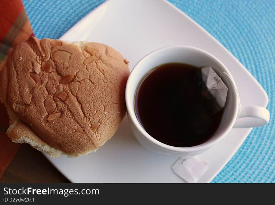 Cup of tea with chinese sponge cake besides it. Cup of tea with chinese sponge cake besides it