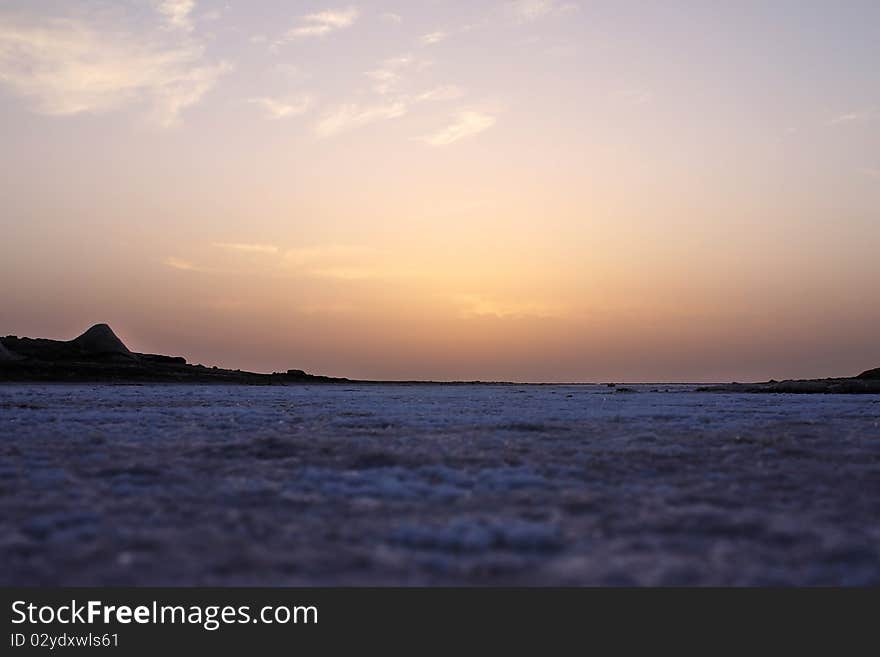 Sunrise in the desert of salt, close-up view of the salt crystals