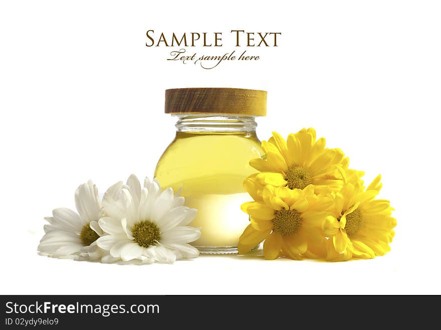 Oil and flowers isolated on white