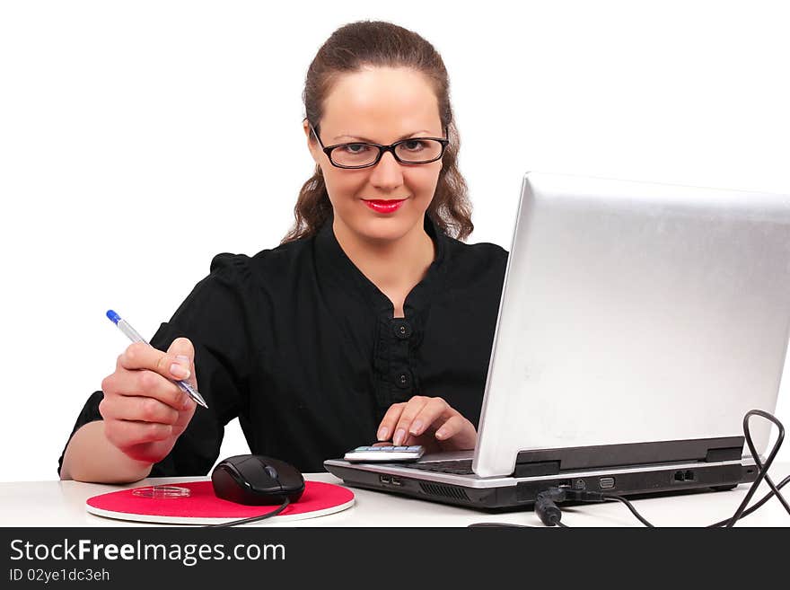 Businesswoman in glasses in office, working on a laptop. Businesswoman in glasses in office, working on a laptop