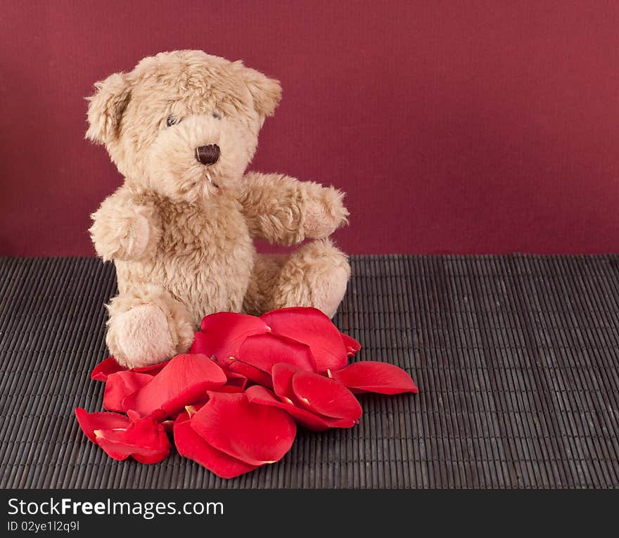 Brown Teddy Bear with Pile of Roses