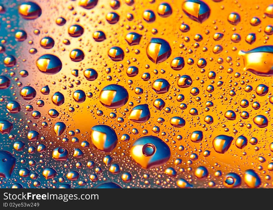 Background of blue and yellow-colored droplets. Background of blue and yellow-colored droplets