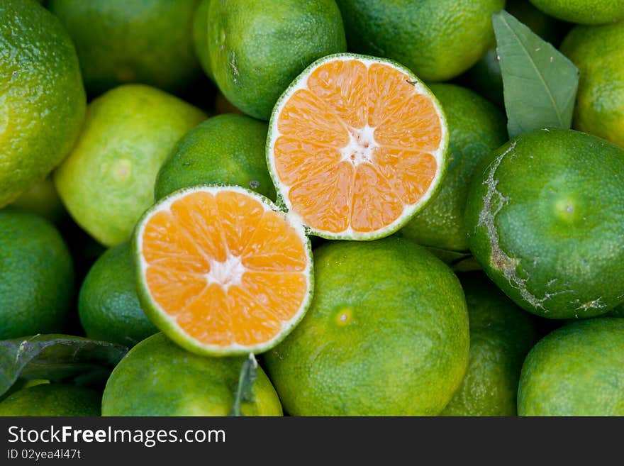 Green tangerines at a market place