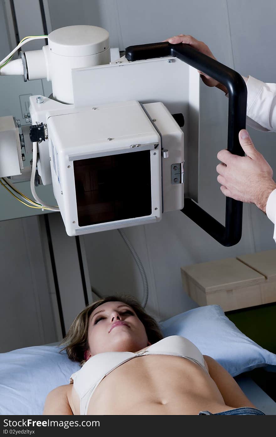 Young woman receiving x-ray scan. Young woman receiving x-ray scan