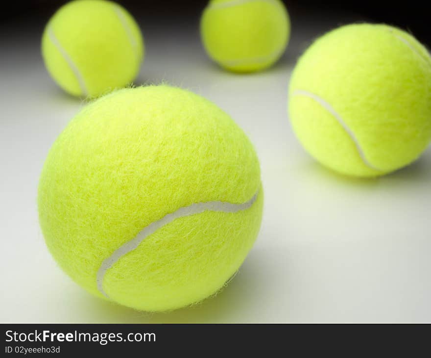 Tennis balls on white surface ,for various tennis,recreation and sport themes. Tennis balls on white surface ,for various tennis,recreation and sport themes