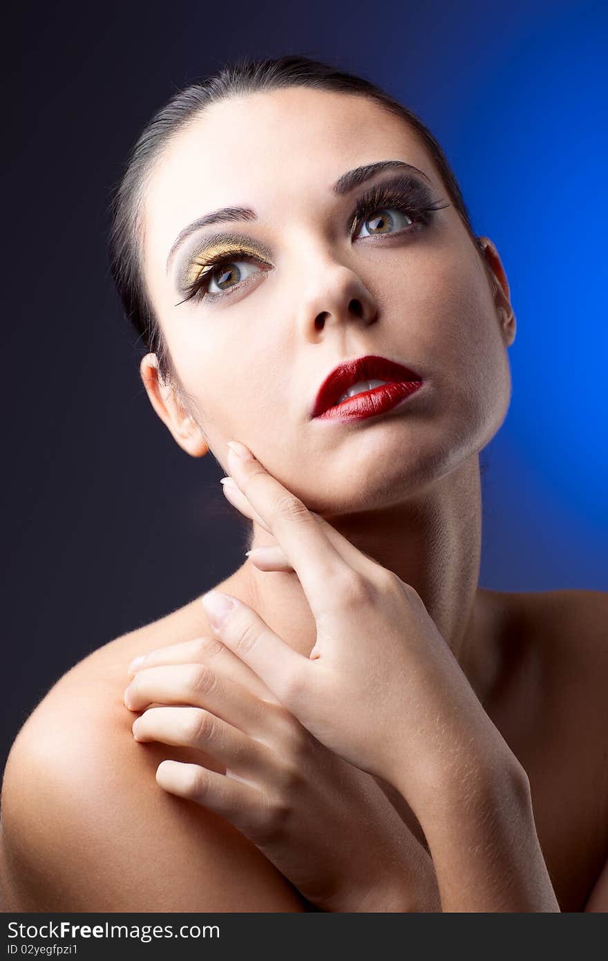 Beautiful woman over color background with beautiful makeup