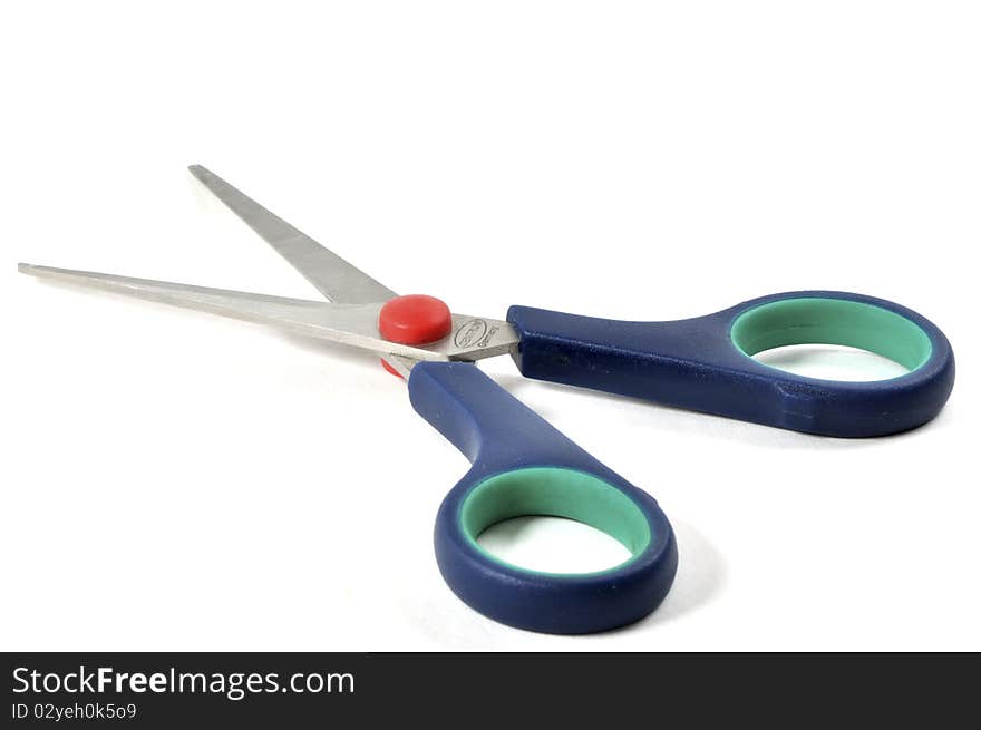 Blue red and green plastic scissors