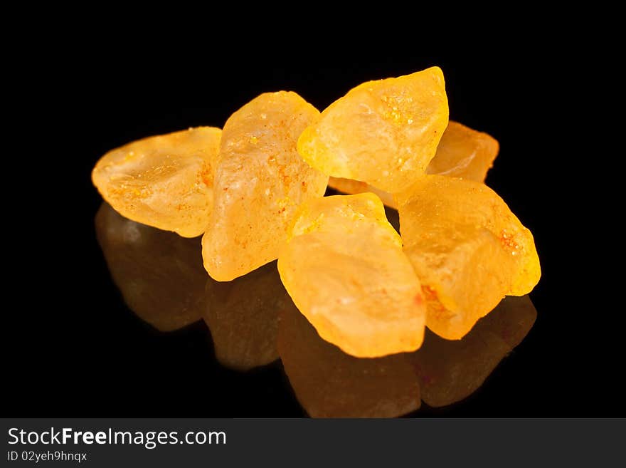 Bath salts with orange extract on a black background. Macro photography. Bath salts with orange extract on a black background. Macro photography.