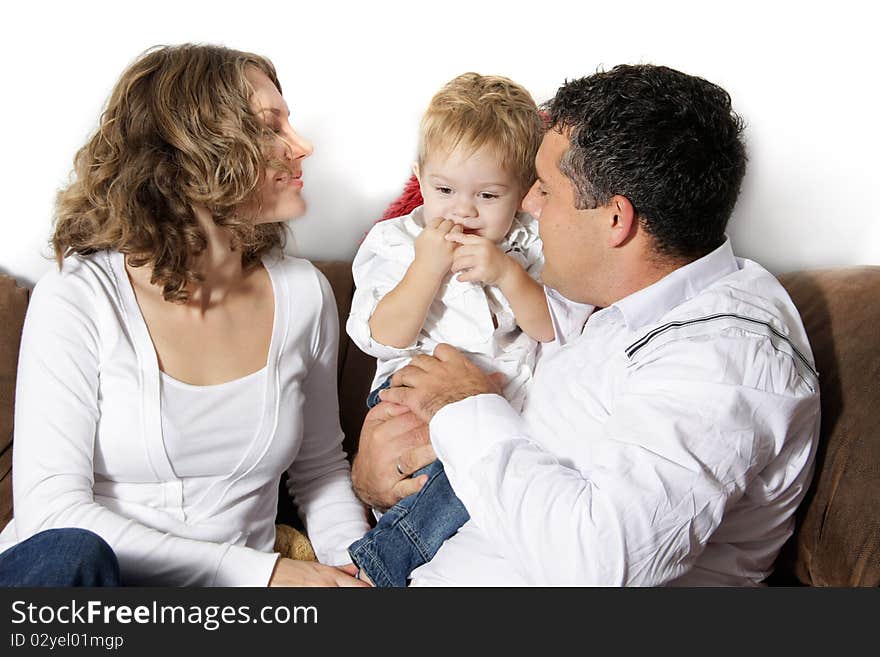 Young happy family at home over white